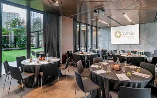Modern event space with round tables, ideal for corporate meetings and social gatherings.