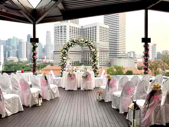 Wedding venue at Naumi Hotel Singapore with floral arch and city skyline backdrop.
