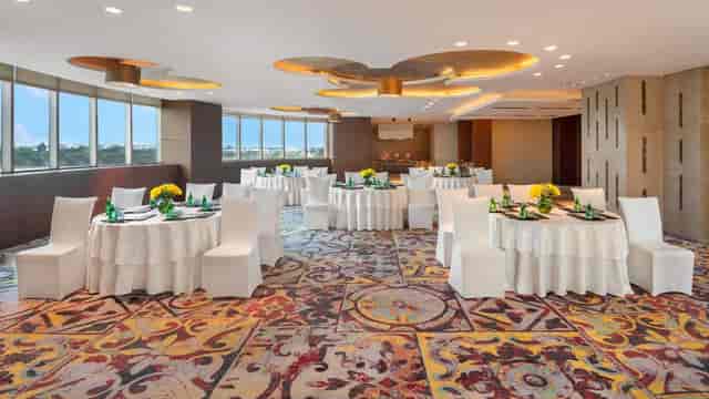 Banquet Hall at Crowne Plaza Greater Noida with elegant round tables for corporate events.