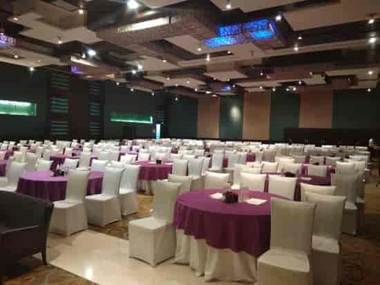 Spacious conference center hall with purple tables, ideal for events and weddings.