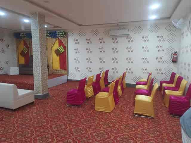 Banquet Hall in Hawala Kalan, featuring colorful chairs for meetings and workshops.