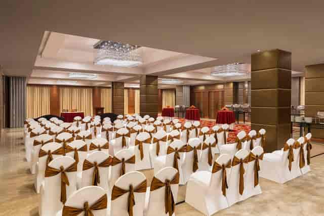 Elegant meeting room with draped chairs at Country Inn & Suites for events and gatherings.
