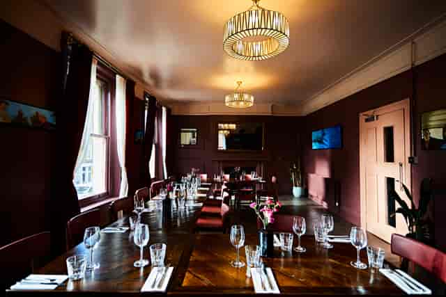 Private dining room at The Royal Oak, featuring a long wooden table for corporate events.