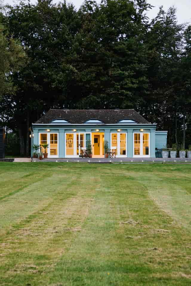 Hawarden Castle Pavilion with blue exterior, ideal for events and retreats.