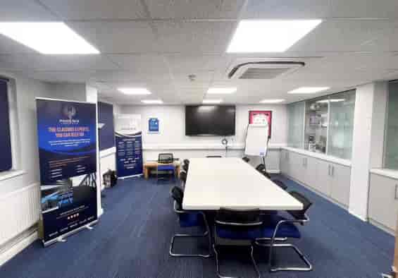 Conference room with central table, ergonomic chairs for professional meetings and events.