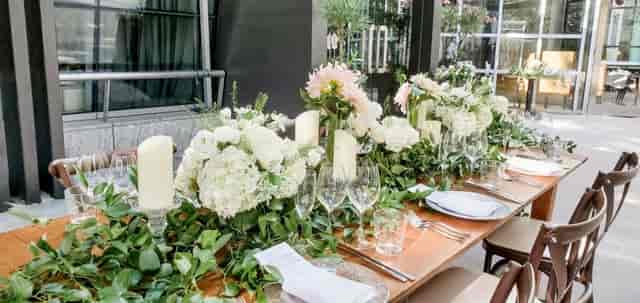 Elegant table setting with floral arrangements for a meeting at Catalyst Restaurant.