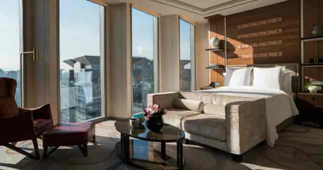 Modern hotel suite with large windows, perfect for intimate meetings and retreats.