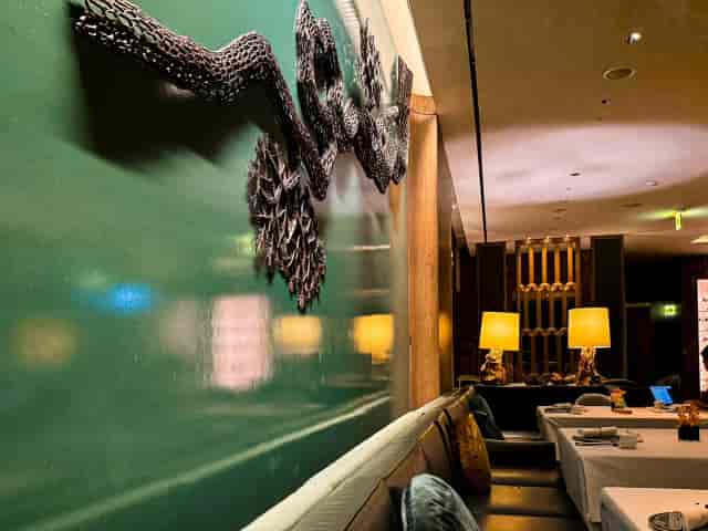 Elegant dining space at Yu Yuan, featuring textured wall art for upscale events.