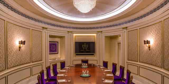 Elegant boardroom at The Ritz-Carlton, Dubai with round table for executive meetings.