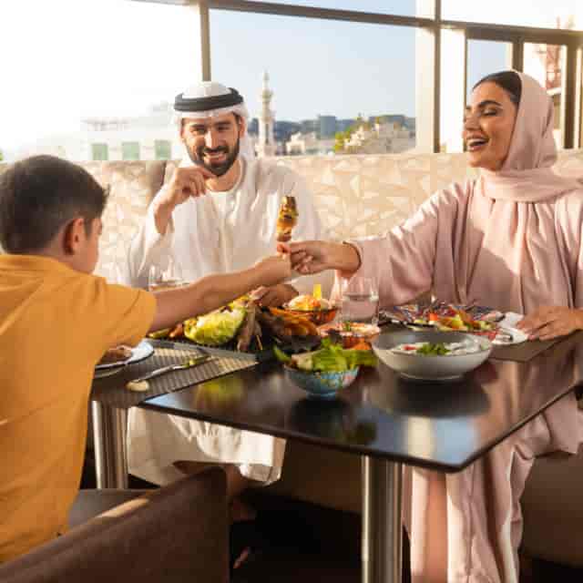 Family dining at Swissôtel Al Ghurair, showcasing vibrant meals for events.