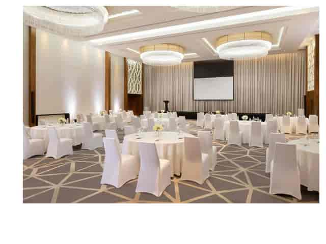 Meeting room at Sheraton Grand Dubai with elegant round tables for corporate events.