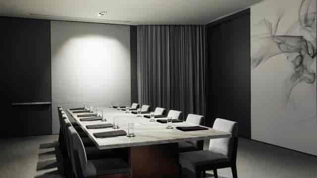 Modern conference room with marble table at Talk & Play, ideal for meetings and events.
