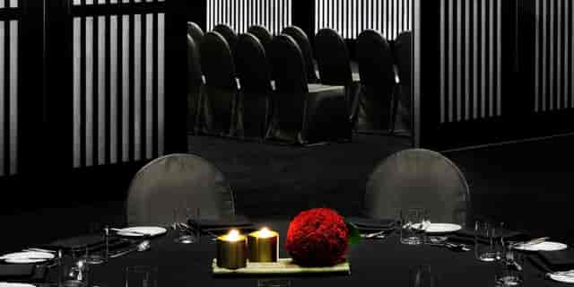 Elegant dining setup with red flowers in Armani Hotel Dubai event space.