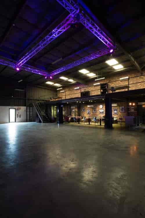 Versatile industrial event space with exposed brick, ideal for corporate meetings and social gatherings.