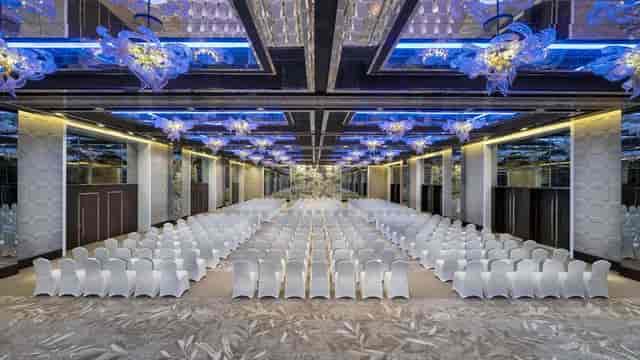 Elegant Creek Ballroom in Dubai with white chairs for conferences and seminars.