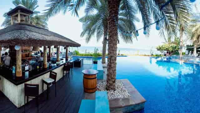 Outdoor bar at Riva Beach with pool, ideal for cocktail receptions and events.