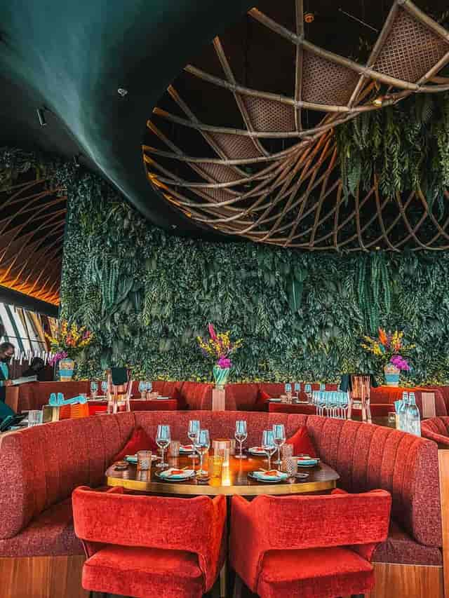 Vibrant SUSHISAMBA dining room with lush greenery, perfect for upscale events and gatherings.