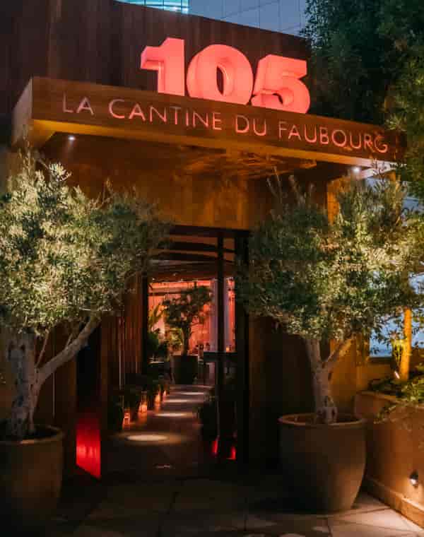 Private dining entrance at La Cantine Du Faubourg, warm lighting, ideal for events.