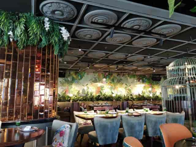 Vibrant Mama Zonia dining room with lush greenery, ideal for upscale events and gatherings.