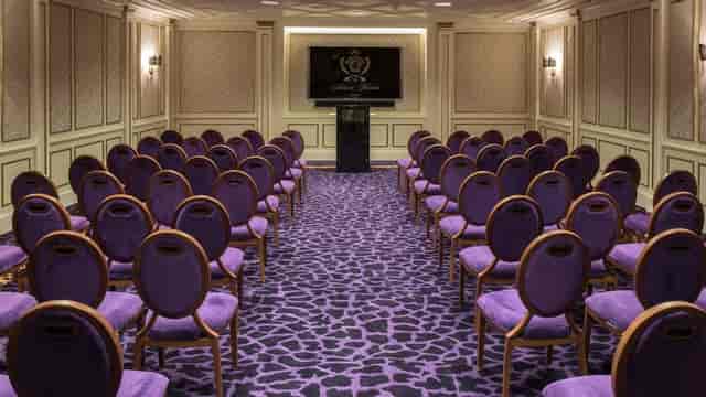 Executive meeting room at Palazzo Versace Dubai with elegant purple carpet, ideal for workshops.