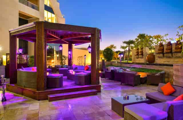 Stylish outdoor lounge at Private Raffles Garden, ideal for evening receptions and networking.