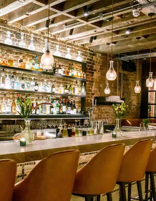 Stylish Sucre Bar with spirits display, perfect for cocktail receptions and networking events.