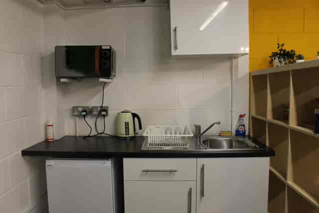 Meeting room kitchenette in Tooting Works with microwave, ideal for events and meetings.