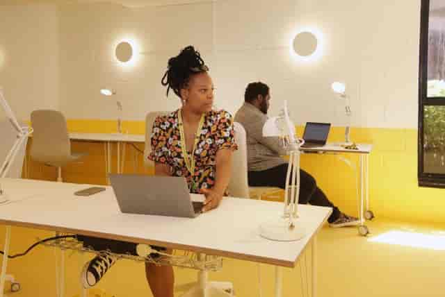 Modern event space in Tooting Works with bright yellow accents for workshops and meetings.