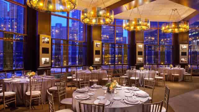 Elegant event space at Sheraton Grand Chicago with round tables and city views.