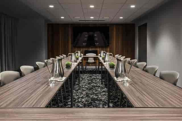 Modern meeting room in Virgin Hotels Chicago, featuring a sleek table for corporate events.