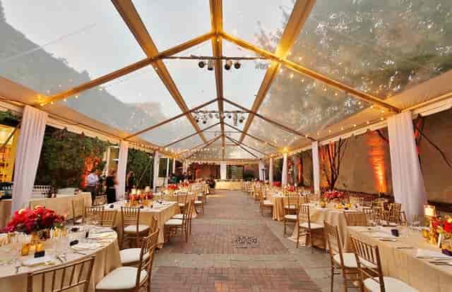 Elegant outdoor event space with clear tent, ideal for weddings and corporate events.