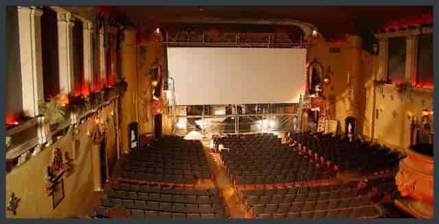 Spacious Music Box Theatre lounge with large screen, ideal for events and screenings.