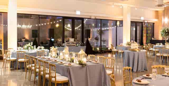 Rooftop deck event space with elegant tables and DJ setup for sophisticated gatherings.