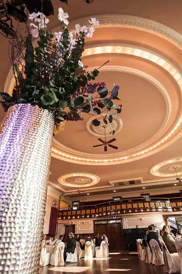 Elegant banquet hall with crystal vase centerpiece, ideal for upscale celebrations.