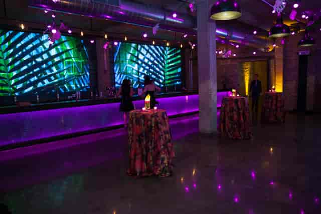 Vibrant Mezzanine event space with sleek bar, ideal for cocktail receptions and gatherings.