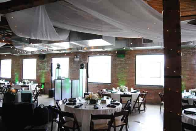 Elegant event space at The Fremont, featuring round tables and floral centerpieces.