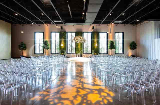 Modern conference center with acrylic chairs, ideal for weddings and corporate events.