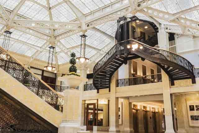 Elegant staircase under glass ceiling in The Rookery lobby, perfect for upscale events.