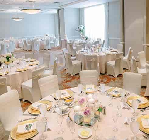 Bluebonnet Ballroom at The Whitehall Houston, elegant wedding banquet hall with floral centerpieces.