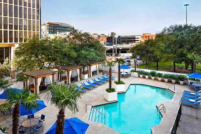 Outdoor pool area at The Whitehall Houston, ideal for networking events and relaxation.