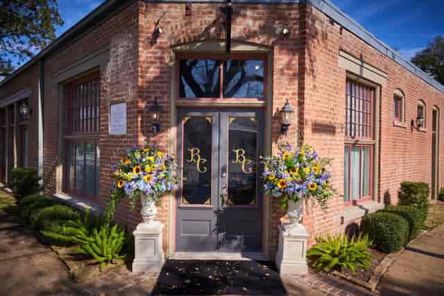 Rose Cottage entrance with floral arrangements, ideal for corporate events and gatherings.