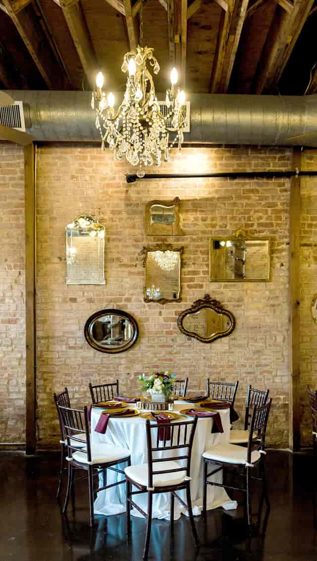 Vintage mirrors on rustic brick in Grand Hall, ideal for stylish events and receptions.