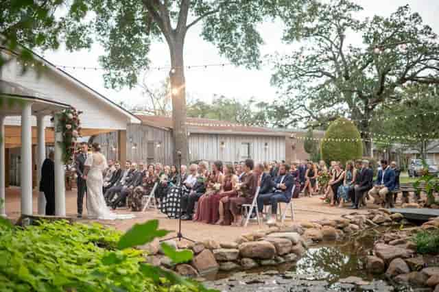 Outdoor wedding ceremony at Butler's Courtyard gazebo with elegant string lights.