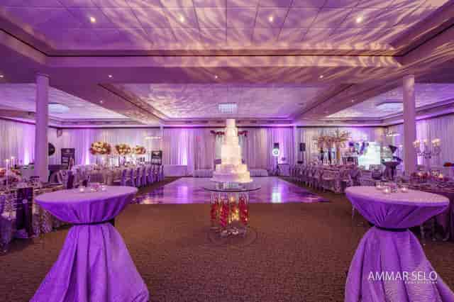 Elegant event hall with purple lighting, ideal for weddings and upscale gatherings.