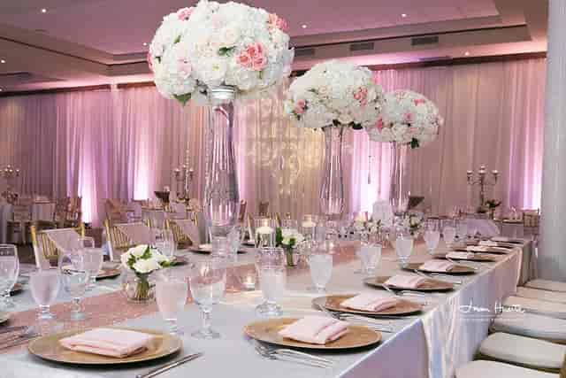 Elegant banquet table with floral centerpieces for weddings and upscale events.