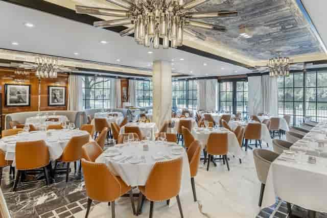 Sophisticated dining space with round tables for corporate events and private gatherings.