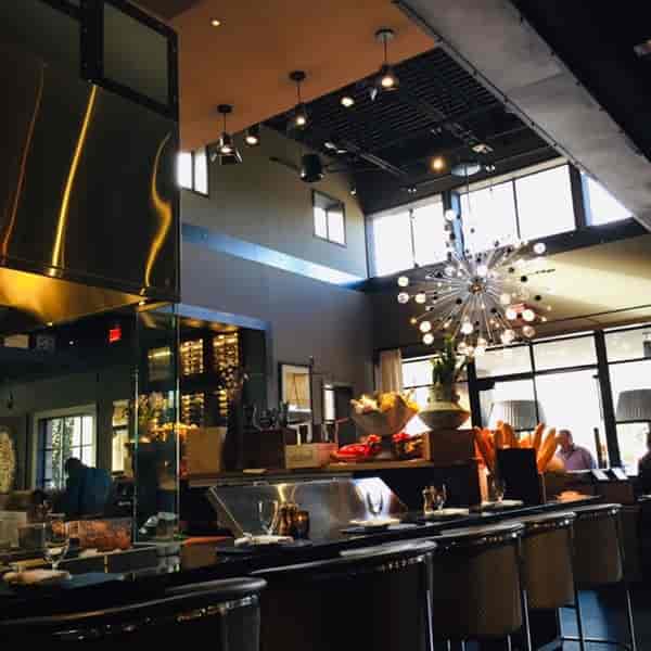 Atrium at Willie G's with elegant chandelier, perfect for gatherings and networking events.