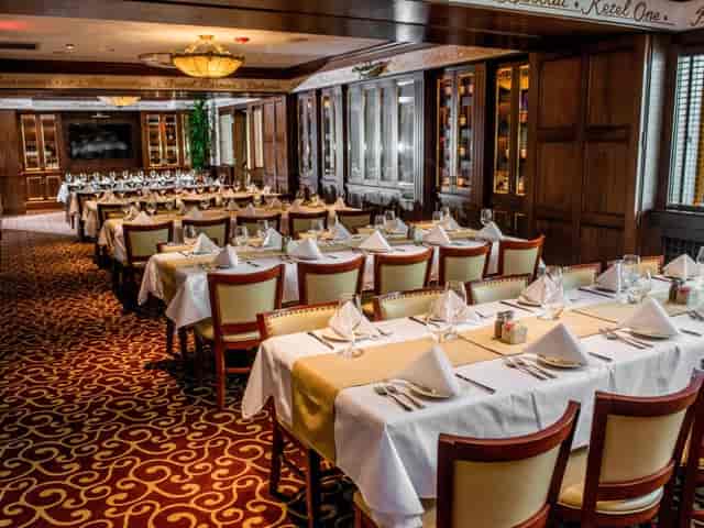 Elegant banquet room with neatly set tables for corporate events at Pappadeaux.