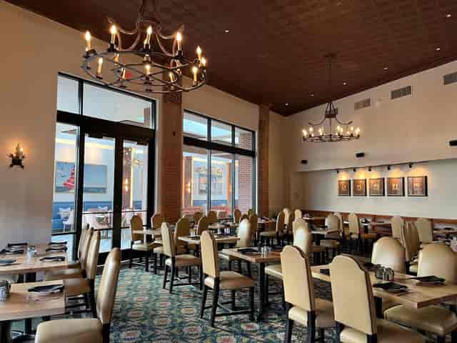 Elegant restaurant interior with large windows, perfect for corporate events and gatherings.