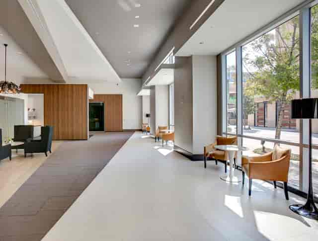 Modern hotel lobby with natural light, ideal for meetings and networking events.